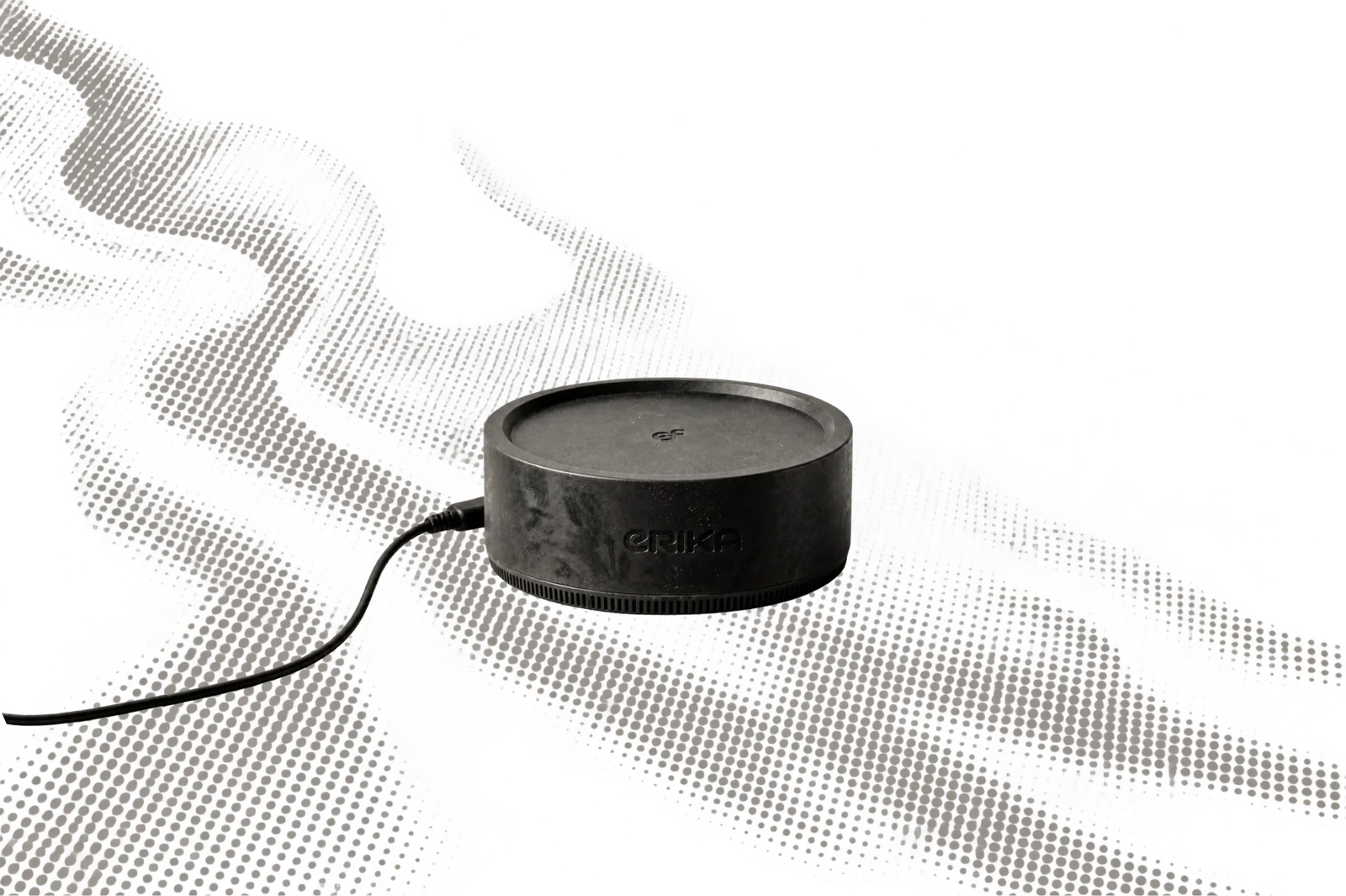 The ERIKA computer connected to power across a halftone field of hands