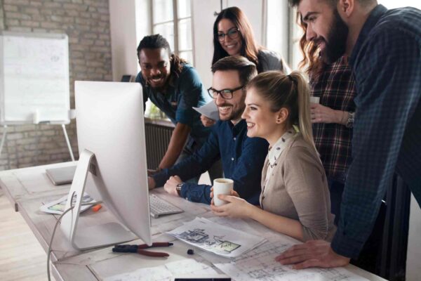 Marketing team analyzing course sales funnel on computer to improve webinar lead generation and online course conversions.
