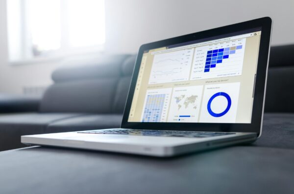 A laptop screen displaying a detailed Google Ads performance dashboard for real estate course creators.