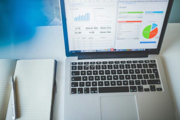 A laptop showing a Google Ads budget and performance dashboard for real estate course creators and educators.