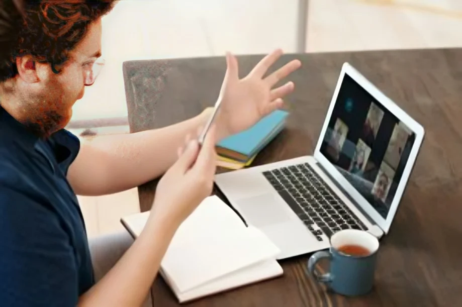 A man hosting a video call on a laptop, demonstrating webinar funnel marketing for real estate course enrollments.